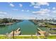 Expansive waterfront view from the balcony showcasing lush greenery, boats, and docks at 344 Capri Blvd, Treasure Island, FL 33706