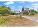 Exterior view of a home with mature trees and a chain-link fence at 3614 Fortner Rd, Plant City, FL 33567