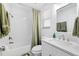 Well-maintained bathroom featuring white subway tiles, shower, and vanity at 3801 Carroway St, Tampa, FL 33619