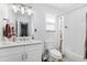 Bright bathroom featuring a white vanity, large mirror, tiled shower, and contemporary fixtures creating a fresh, clean space at 3801 Carroway St, Tampa, FL 33619