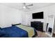Bedroom with sleek dresser, wall-mounted TV, stylish mirror, and ceiling fan at 3801 Carroway St, Tampa, FL 33619