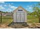 Well-maintained shed with double doors and decorative trim, offering backyard storage solutions at 3801 Carroway St, Tampa, FL 33619