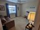 Relaxing room with a ceiling fan, comfortable sofa, and natural light streaming through the window at 38225 Ironwood Pl # 38225, Zephyrhills, FL 33542