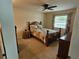 Cozy bedroom with a ceiling fan, window, bed and a warm inviting ambiance at 38225 Ironwood Pl # 38225, Zephyrhills, FL 33542