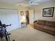Cozy bedroom with a ceiling fan, double door closet, and comfortable seating area at 38225 Ironwood Pl # 38225, Zephyrhills, FL 33542