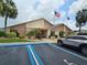 Well-maintained clubhouse showcasing an inviting entrance, landscaping, and convenient accessible parking at 38225 Ironwood Pl # 38225, Zephyrhills, FL 33542