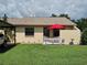 Charming single-story home with a well-manicured lawn and a cute, decorative white picket fence at 38225 Ironwood Pl # 38225, Zephyrhills, FL 33542