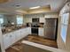 Modern kitchen featuring stainless steel appliances, granite countertops, and ample cabinet space at 38225 Ironwood Pl # 38225, Zephyrhills, FL 33542