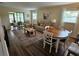 Spacious living room with wood floors, comfortable seating, and access to a screened-in lanai at 38225 Ironwood Pl # 38225, Zephyrhills, FL 33542