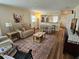 Inviting living room with warm tones, comfortable seating, and an open layout to the kitchen at 38225 Ironwood Pl # 38225, Zephyrhills, FL 33542