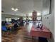 Expansive meeting room with hardwood floors, neutral walls, and ample tables/seating perfect for gatherings at 38225 Ironwood Pl # 38225, Zephyrhills, FL 33542
