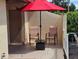 Relaxing outdoor patio area with comfortable seating under a bright red umbrella at 38225 Ironwood Pl # 38225, Zephyrhills, FL 33542