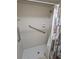 Accessible tiled shower with grab bars and a shower curtain for privacy at 38225 Ironwood Pl # 38225, Zephyrhills, FL 33542