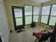 Bright sunroom filled with natural light from large windows and featuring comfortable seating at 38225 Ironwood Pl # 38225, Zephyrhills, FL 33542