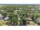 Expansive aerial view of a property surrounded by lush trees in a serene neighborhood at 4815 N Falkenburg Rd, Tampa, FL 33610