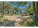 View of the exterior of a single-story home with overgrown lawn and a 'Private Property' sign at 4815 N Falkenburg Rd, Tampa, FL 33610