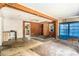 Interior view of a distressed living room with damaged floors and walls at 4815 N Falkenburg Rd, Tampa, FL 33610