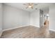 Spacious bedroom with hardwood floors and a ceiling fan, leading into the bathroom at 5000 Culbreath Key Way # 8-319, Tampa, FL 33611