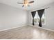 Bright bedroom with wood-look floors, ceiling fan, and plenty of natural light at 5000 Culbreath Key Way # 8-319, Tampa, FL 33611