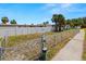 Community dog park with waste station and gravel walking path, surrounded by white and chainlink fences at 5000 Culbreath Key Way # 8-319, Tampa, FL 33611