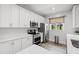 Modern kitchen with white cabinets, stainless steel appliances, quartz counters, and ample counter space at 5000 Culbreath Key Way # 8-319, Tampa, FL 33611