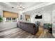 Bright living room with hardwood floors, large windows, neutral paint, and a comfortable gray sofa at 5000 Culbreath Key Way # 8-319, Tampa, FL 33611