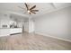 Open-concept living room featuring hard surface floors and a partial kitchen view at 5000 Culbreath Key Way # 8-319, Tampa, FL 33611