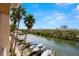 Stunning waterfront view from the condo features palm trees and boat docks at 5000 Culbreath Key Way # 8-319, Tampa, FL 33611