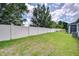 Spacious backyard featuring a well-maintained lawn and a tall white fence for privacy and security at 5732 Stockport St, Riverview, FL 33578