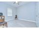 Cozy bedroom featuring tile flooring, a ceiling fan, and natural light at 5732 Stockport St, Riverview, FL 33578