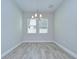 Bright dining room featuring tile flooring, a modern chandelier, and large windows at 5732 Stockport St, Riverview, FL 33578