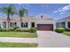 Charming single-story home featuring a well-manicured lawn, neat shrubbery and an attached two car garage at 5732 Stockport St, Riverview, FL 33578