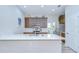 Open kitchen features a center island, quartz countertops, wood cabinets and stainless steel appliances at 5732 Stockport St, Riverview, FL 33578