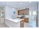 Open kitchen features a center island, quartz countertops, wood cabinets and stainless steel appliances at 5732 Stockport St, Riverview, FL 33578