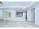 Open-concept living room featuring wood-look tile flooring, neutral wall paint and view to the kitchen at 5732 Stockport St, Riverview, FL 33578