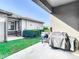 Backyard featuring well-maintained lawn, covered patio, and outdoor cooking area at 5807 Circa Fishhawk Blvd, Lithia, FL 33547