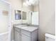 Well-lit bathroom featuring a granite countertop, vanity, and modern fixtures at 5807 Circa Fishhawk Blvd, Lithia, FL 33547