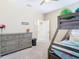 Well-lit bedroom with bunk beds, a dresser, and an open doorway to another room at 5807 Circa Fishhawk Blvd, Lithia, FL 33547