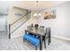 Cozy dining area with a stylish table, blue bench, and staircase in a well-lit home at 5807 Circa Fishhawk Blvd, Lithia, FL 33547