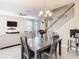Open-concept dining area that flows into the living room, featuring a staircase and modern decor at 5807 Circa Fishhawk Blvd, Lithia, FL 33547