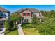 Charming two-story home featuring a landscaped yard, red shutters, and a welcoming front porch entrance at 5807 Circa Fishhawk Blvd, Lithia, FL 33547