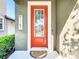 Inviting front door with decorative glass panels, a 'Welcome' sign and manicured plants at 5807 Circa Fishhawk Blvd, Lithia, FL 33547