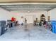 Spacious two car garage featuring a clean epoxy floor and ample storage space at 5807 Circa Fishhawk Blvd, Lithia, FL 33547