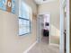 Bright hallway featuring a window and a view into a bedroom with bunk beds at 5807 Circa Fishhawk Blvd, Lithia, FL 33547