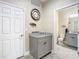 Hallway with powder room featuring a granite-topped vanity, storage, and stylish decor at 5807 Circa Fishhawk Blvd, Lithia, FL 33547