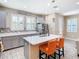 Modern kitchen featuring a center island with seating, stainless steel appliances, and gray cabinets at 5807 Circa Fishhawk Blvd, Lithia, FL 33547