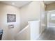 Landing at the top of the staircase with access to bedrooms and a hallway area with decor at 5807 Circa Fishhawk Blvd, Lithia, FL 33547