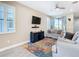 Cozy living room with neutral walls, a ceiling fan, plantation shutters and a sofa with throw pillows at 5807 Circa Fishhawk Blvd, Lithia, FL 33547