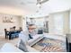Open-concept living room showcasing a sofa, dining area, and kitchen with stainless steel appliances at 5807 Circa Fishhawk Blvd, Lithia, FL 33547