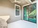 Cozy covered patio with ceiling fan and sliding glass doors leading to the interior at 5807 Circa Fishhawk Blvd, Lithia, FL 33547